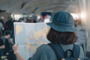 A woman holding a map, symbolizing novelty-seeking behavior and the desire for new experiences.