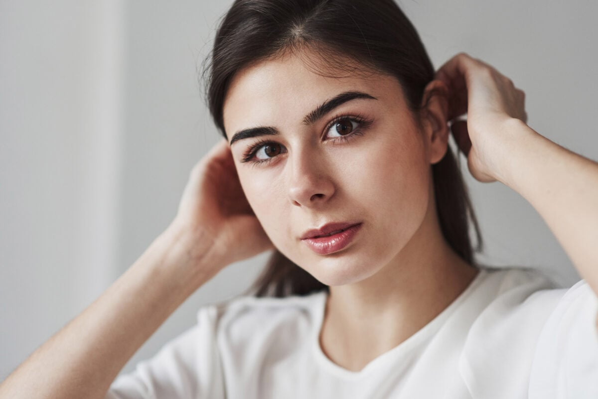 A woman with a noticeable unibrow, showcasing a unique facial feature that may offer insights into her genetic makeup.