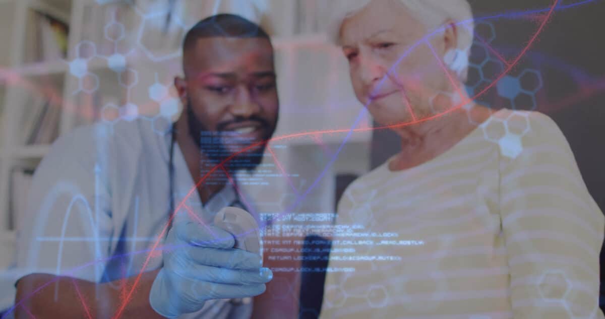 A genetic counselor discusses Nijmegen Breakage Syndrome test results with a patient, showing a DNA chart and medical report