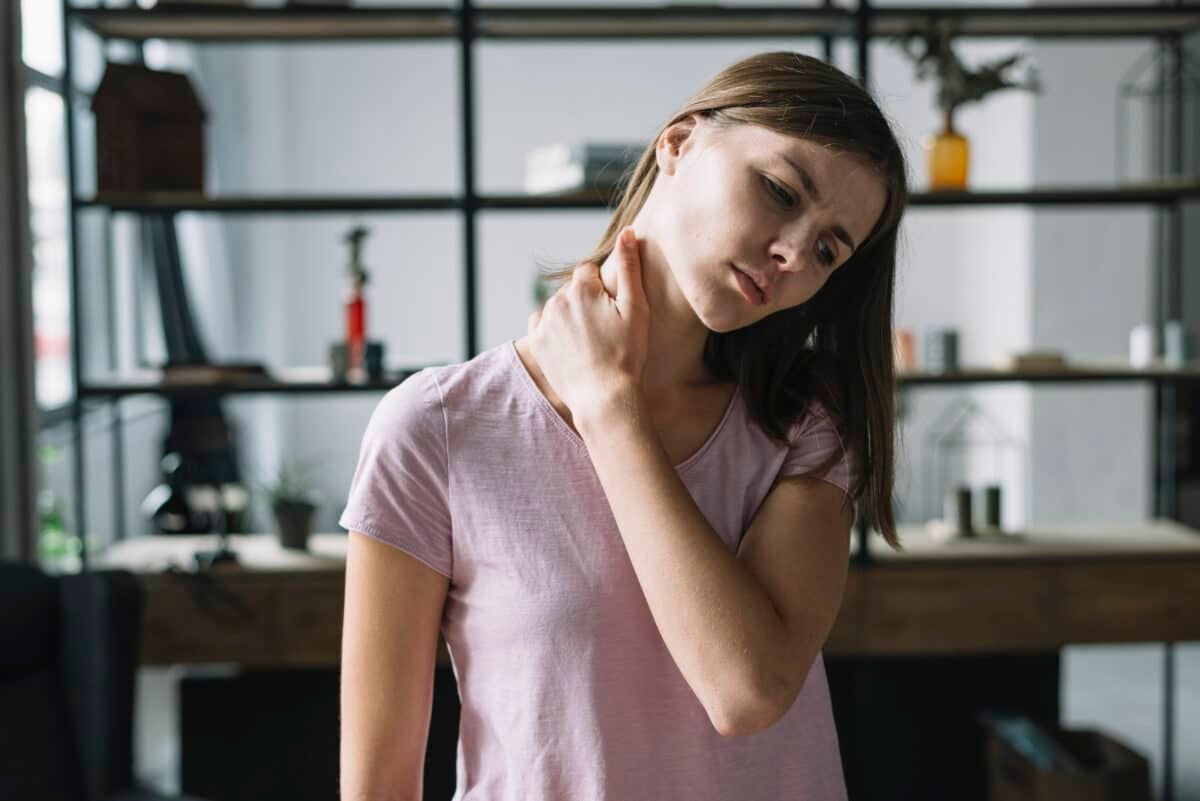 Image of a woman checking her neck, representing thyroid and muscle-related symptoms in Pompe’s Disease.