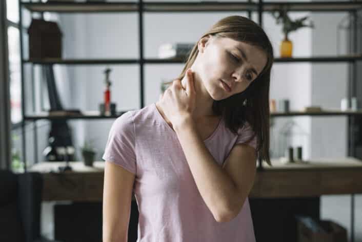 Image of a woman checking her neck, representing thyroid and muscle-related symptoms in Pompe’s Disease.