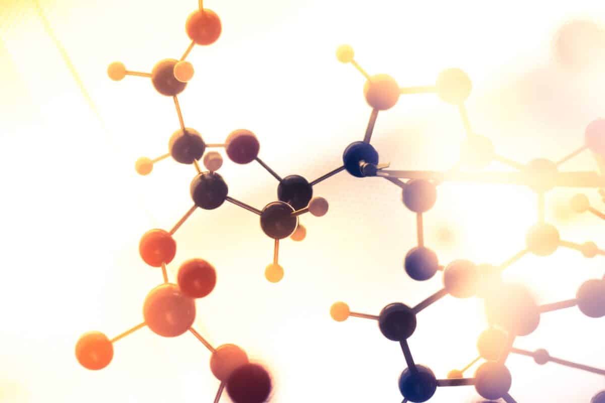 An image of connected atoms in a molecular structure, symbolizing the genetic and biochemical aspects of phenylketonuria (PKU).