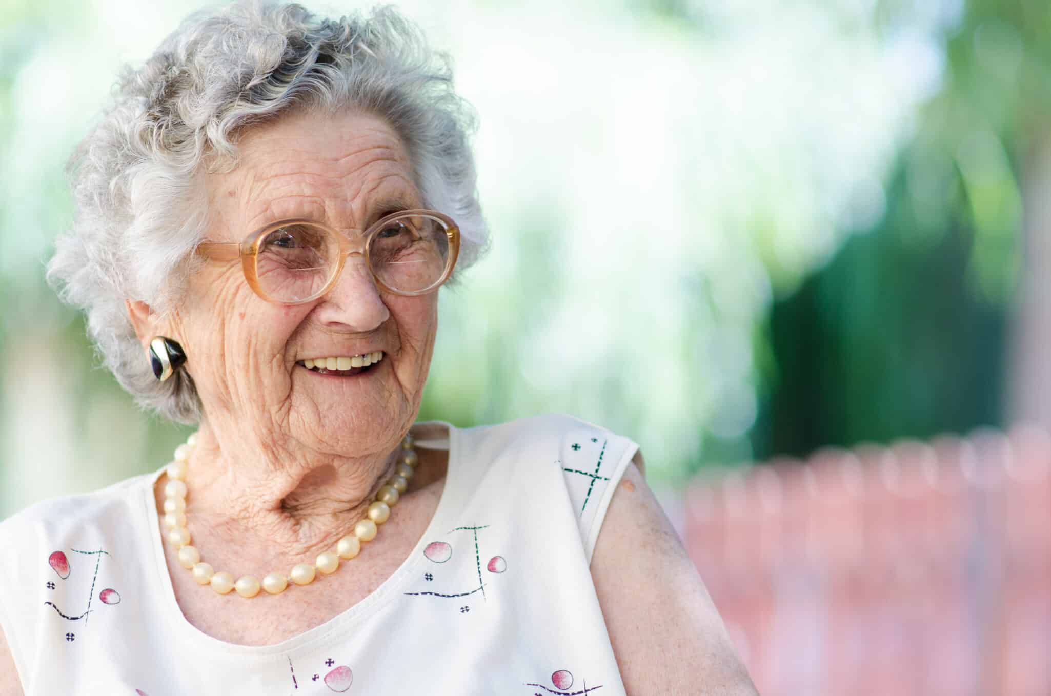 An image of an elderly woman with a serene expression, symbolizing longevity and the impact of the FOXO3 gene on healthy aging.