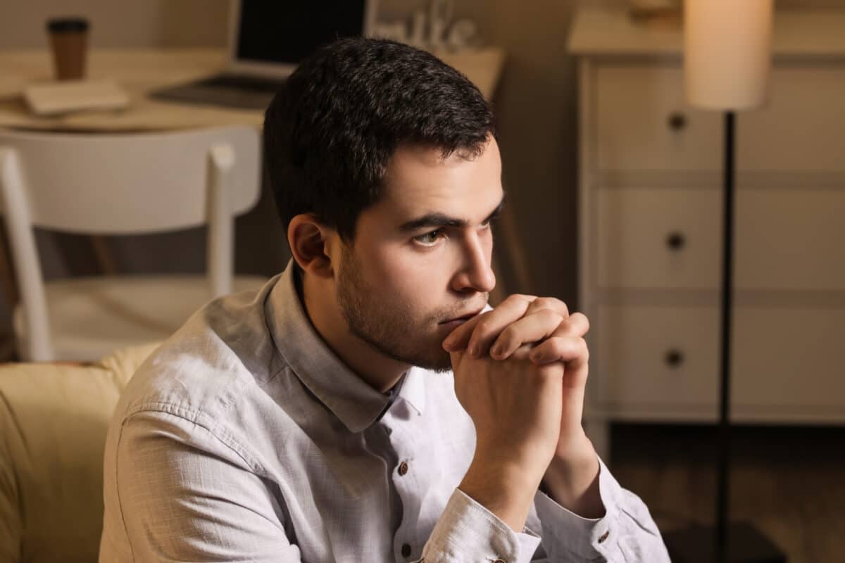 An image of a man deep in thought, representing the challenges and genetic factors linked to male infertility.