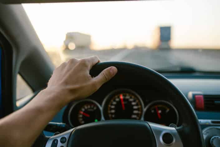 Speeding car on the highway representing the concept of automobile speeding tendency with possible genetic influences