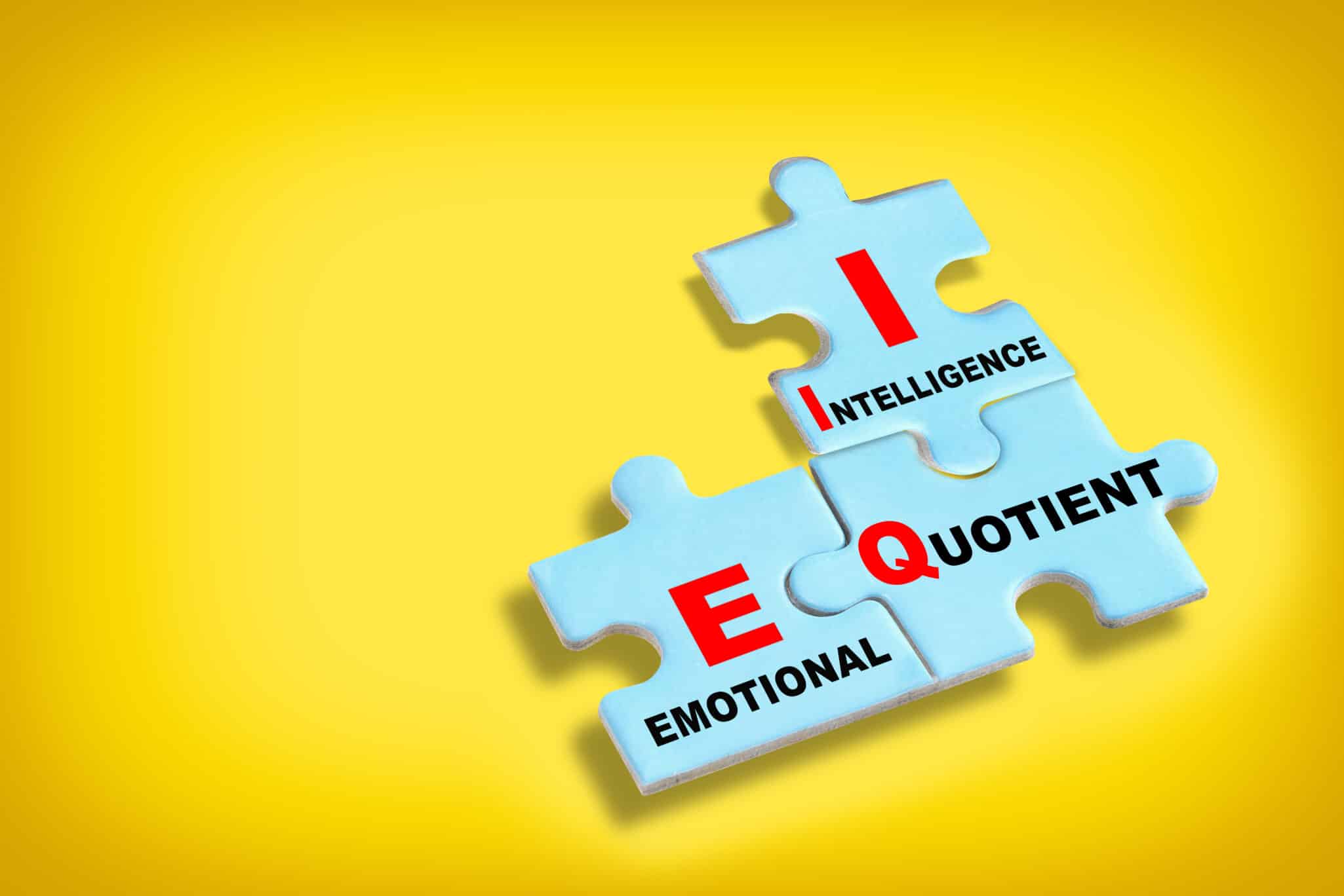Puzzle pieces forming the letters EQ, representing how emotional quotient may have genetic components