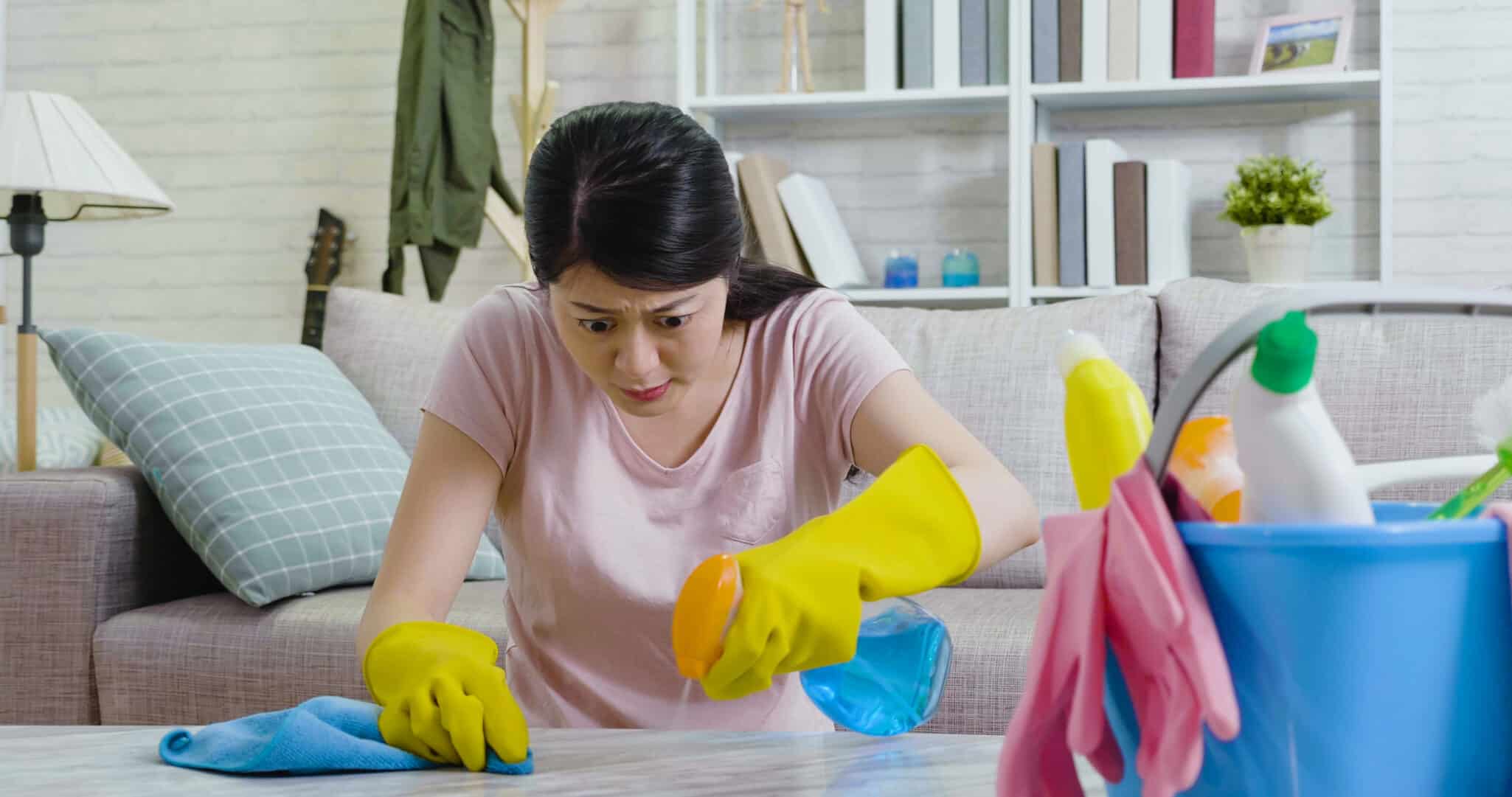Woman intensely cleaning a surface, representing compulsive behavior linked to OCD and genetic predisposition