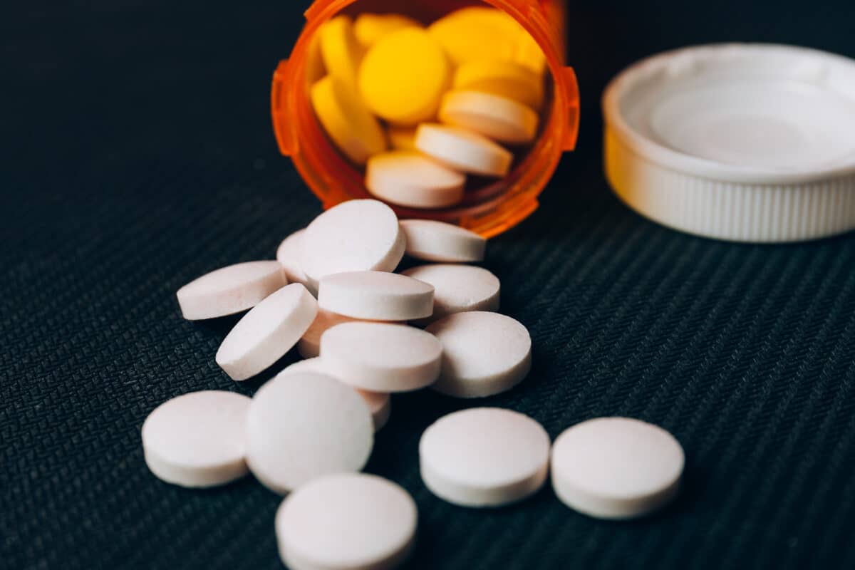 Metformin pills on a surface, representing how genetics can influence drug effectiveness and side effects