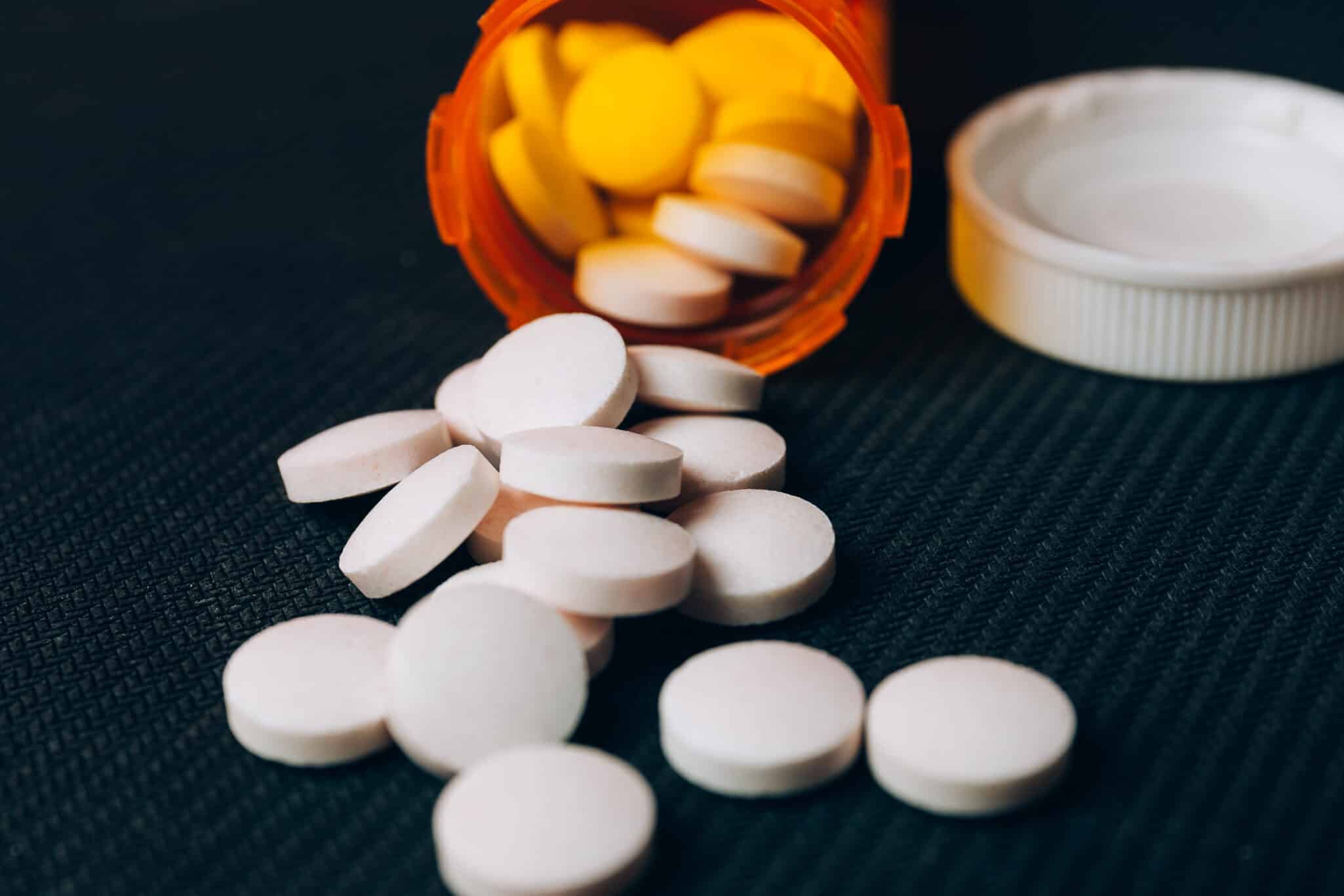 Metformin pills on a surface, representing how genetics can influence drug effectiveness and side effects
